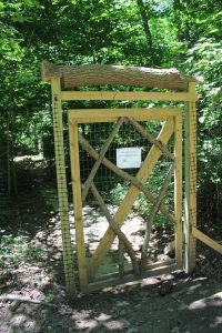 a wood and chicken wire gate