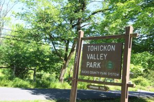 a brown park sign that reads "Tohickon Valley Park, Bucks County Park System"